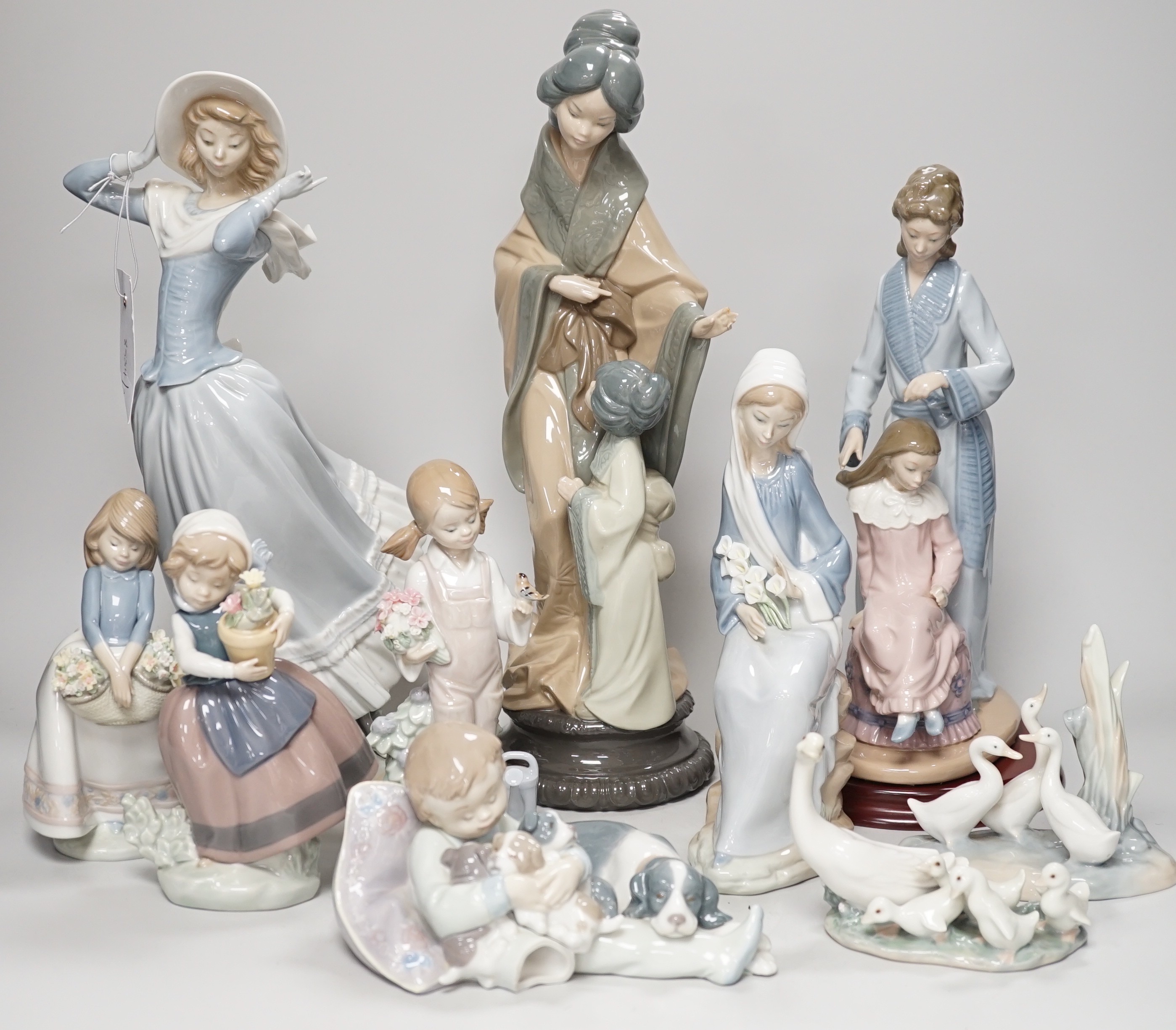 Seven Lladro and two Nao porcelain figures together with another, stuck to base so mark can’t be seen. Tallest 38cm